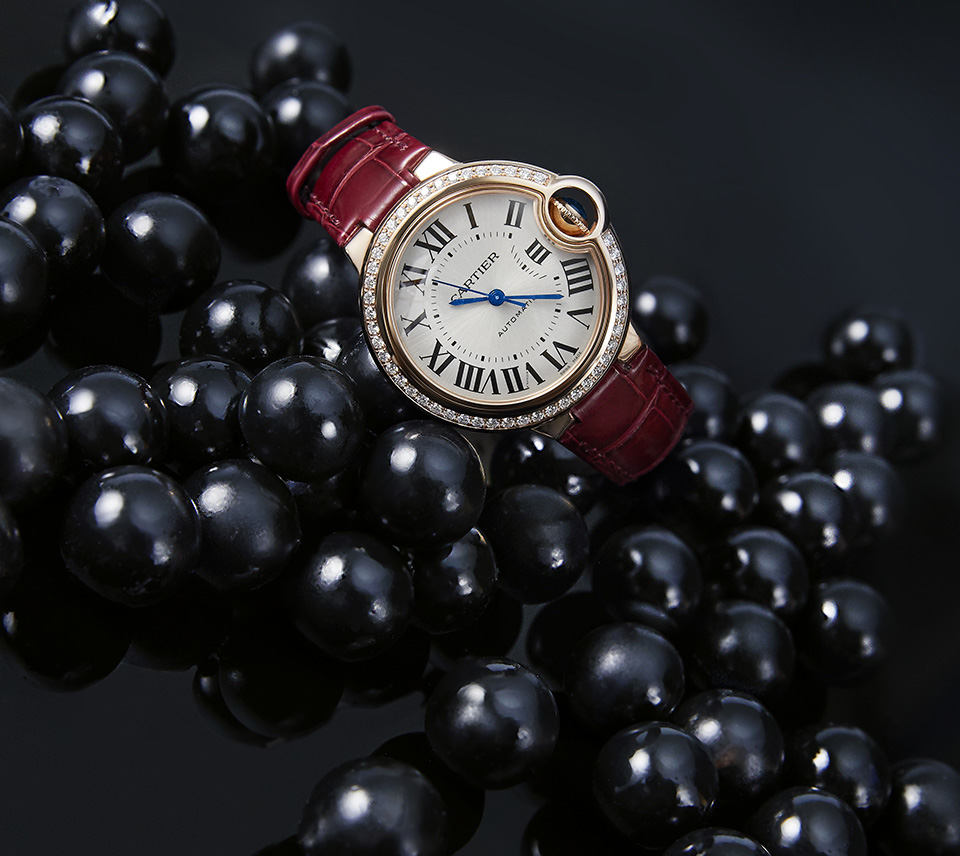 Ballon Bleu de Cartier with silver dial, Roman numerals and blued hands against a black background