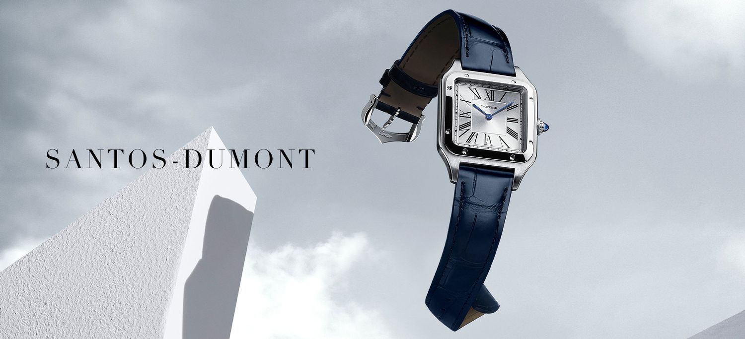A Cartier Santos-Dumont with silver dial, Roman numerals and blue alligator leather strap against a bright, cloudy background featuring the "Santos-Dumont" title.