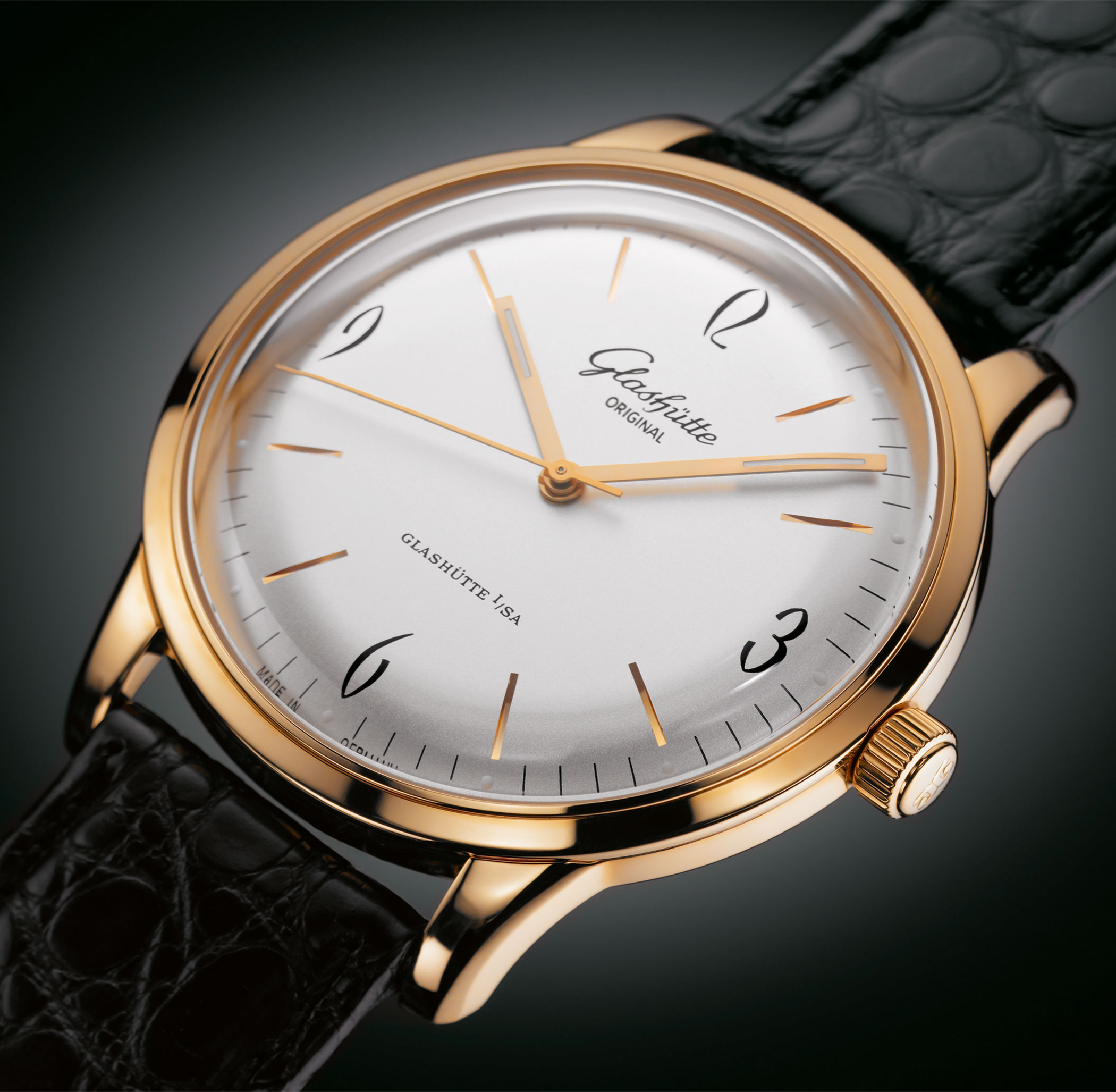 A Glashütte Original Sixties with gold-tone case, silver dial, Arabic numerals and black leather strap.