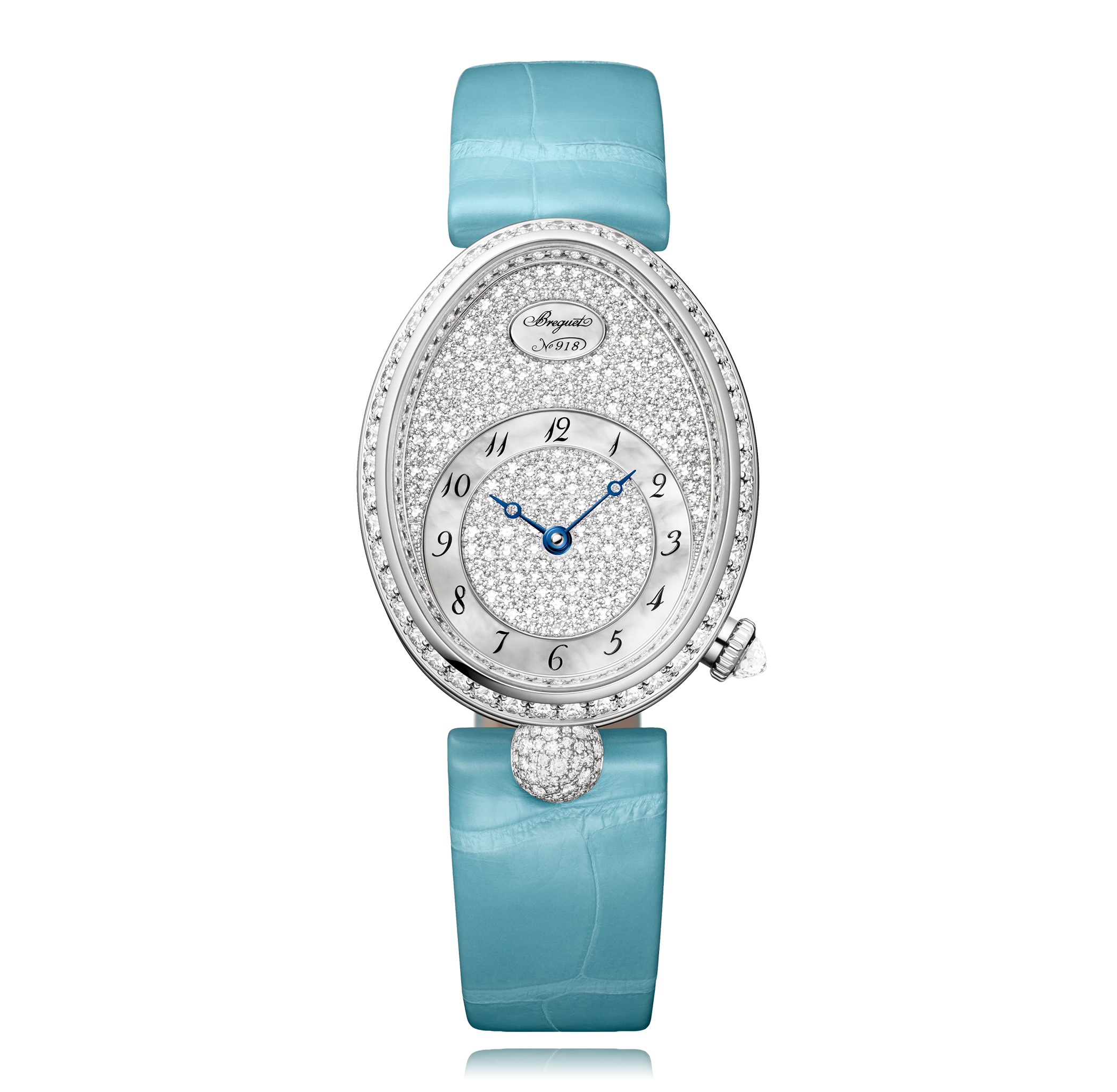 A luxurious watch with an oval white gold case surrounded by diamonds, featuring a white dial with blue Arabic numerals, a teardrop-shaped diamond at 6 o'clock, and a light blue alligator leather strap.