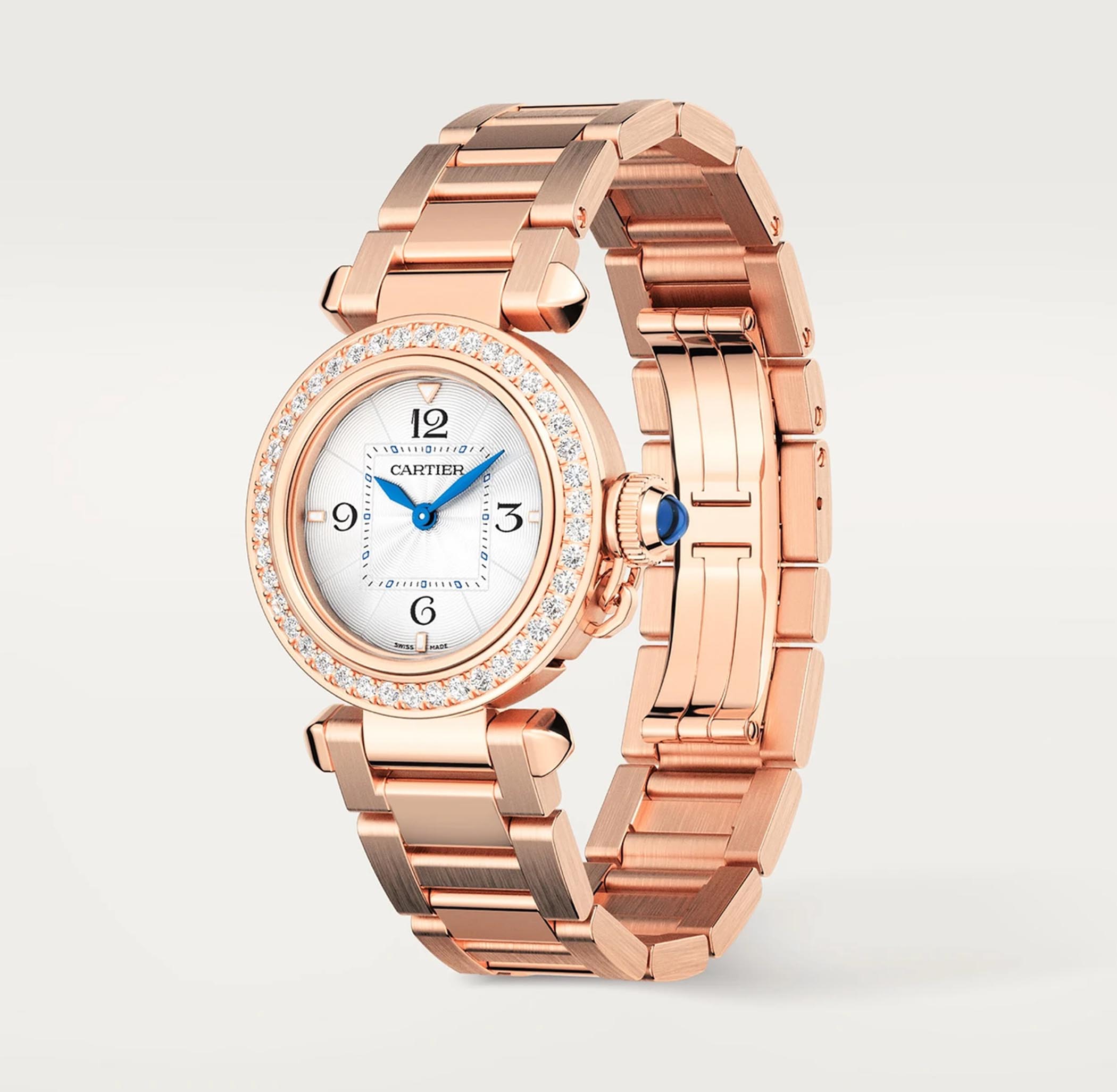 A Pasha de Cartier in rose gold with a diamond-set bezel, silver-tone dial, Arabic numerals and blue hands, on a rose gold link bracelet.