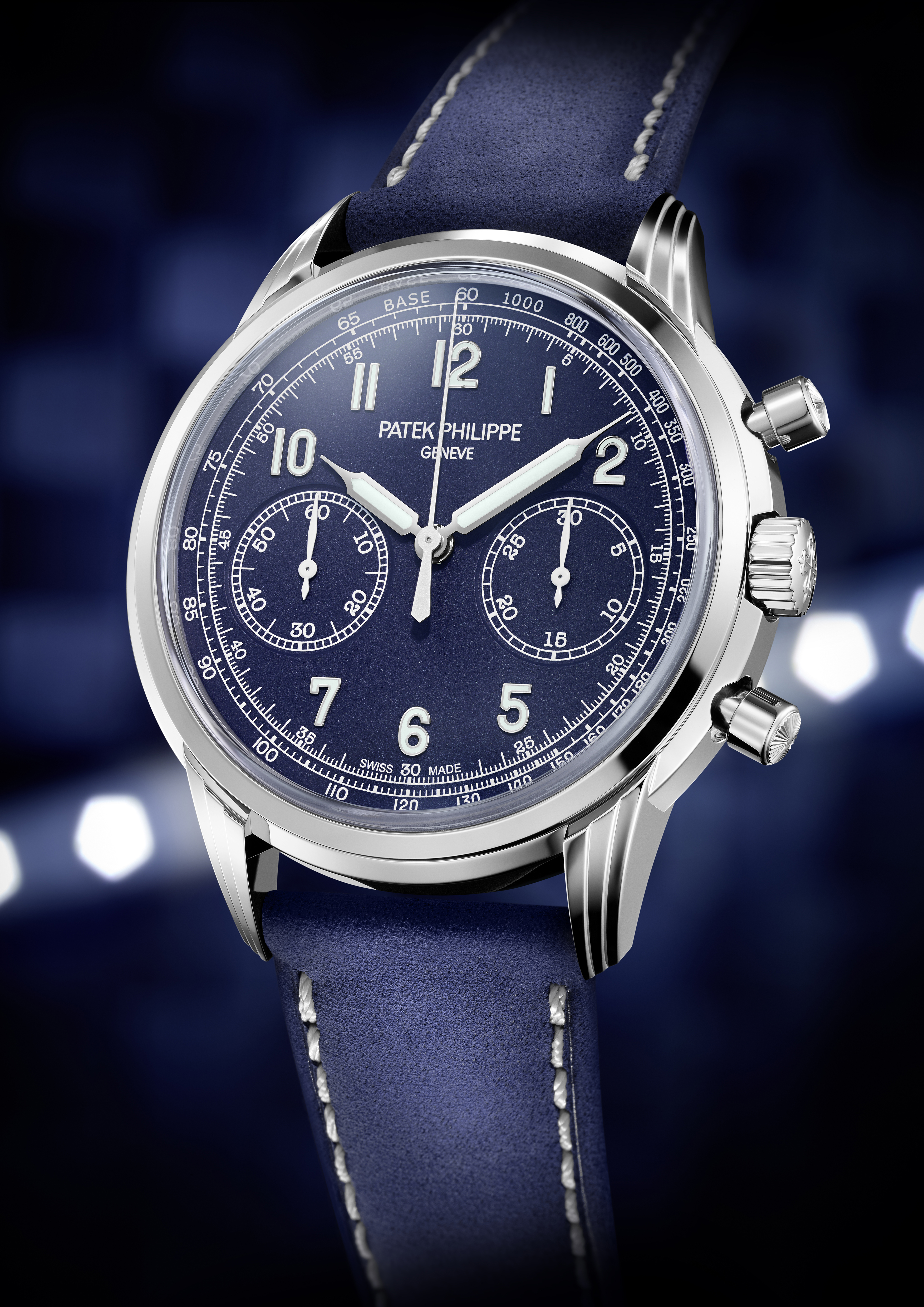 A Patek Philippe chronograph watch with a blue dial, white numerals, and a blue leather strap.