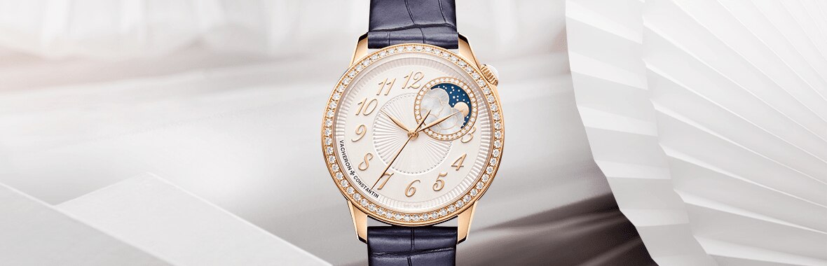 Luxury Vacheron Constantin women’s watch with diamond bezel and moon phase display on leather strap.