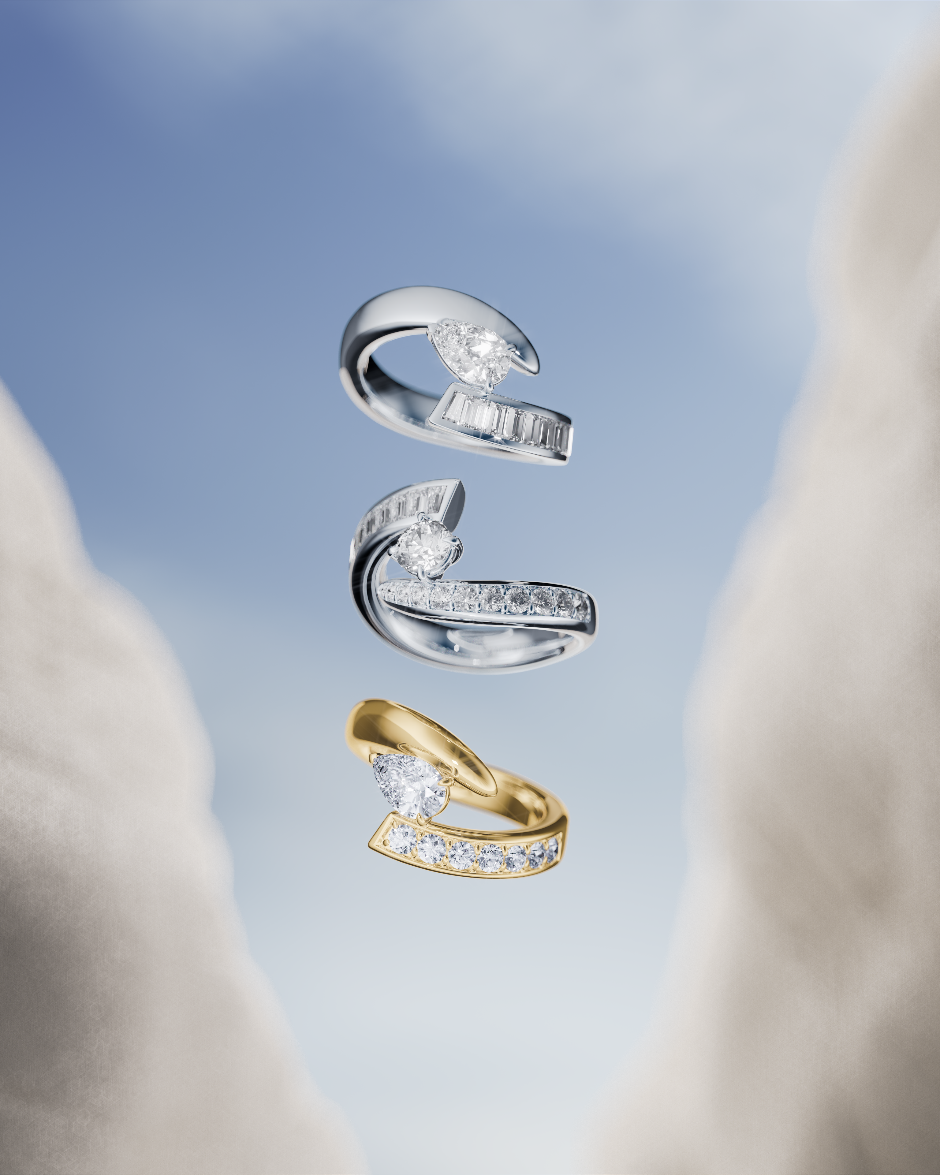 Three diamond rings, two silver and one gold, float against a soft blue background with white fabric on the sides.
