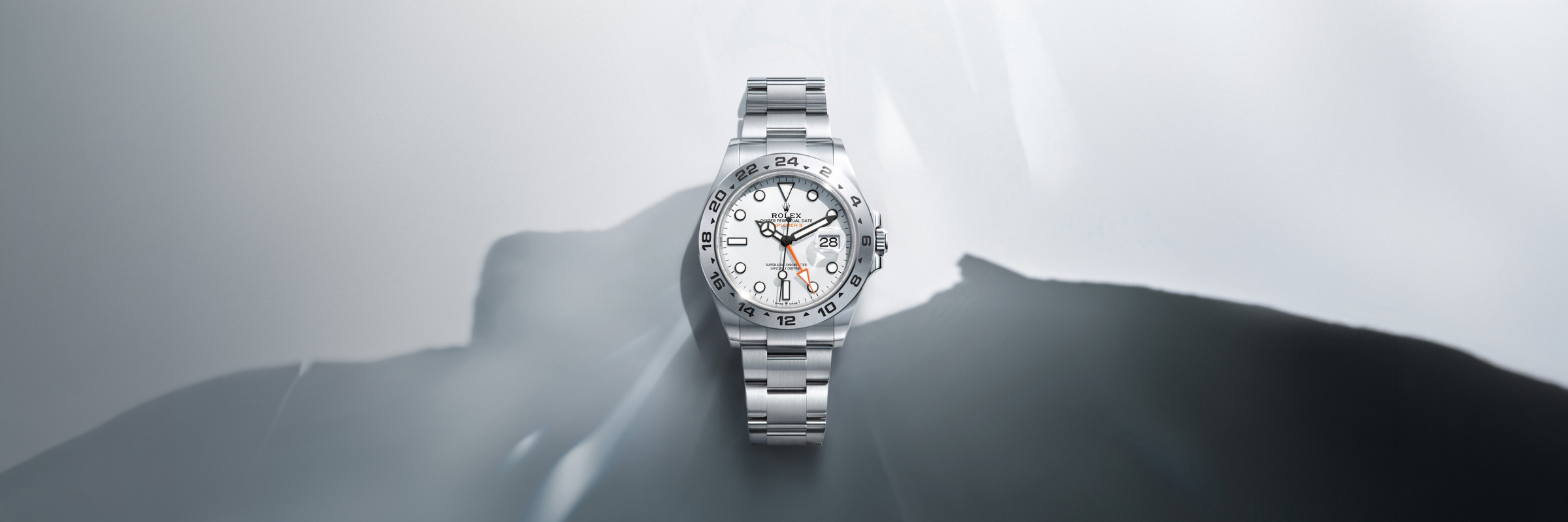 Rolex Explorer II in stainless steel with a white dial.