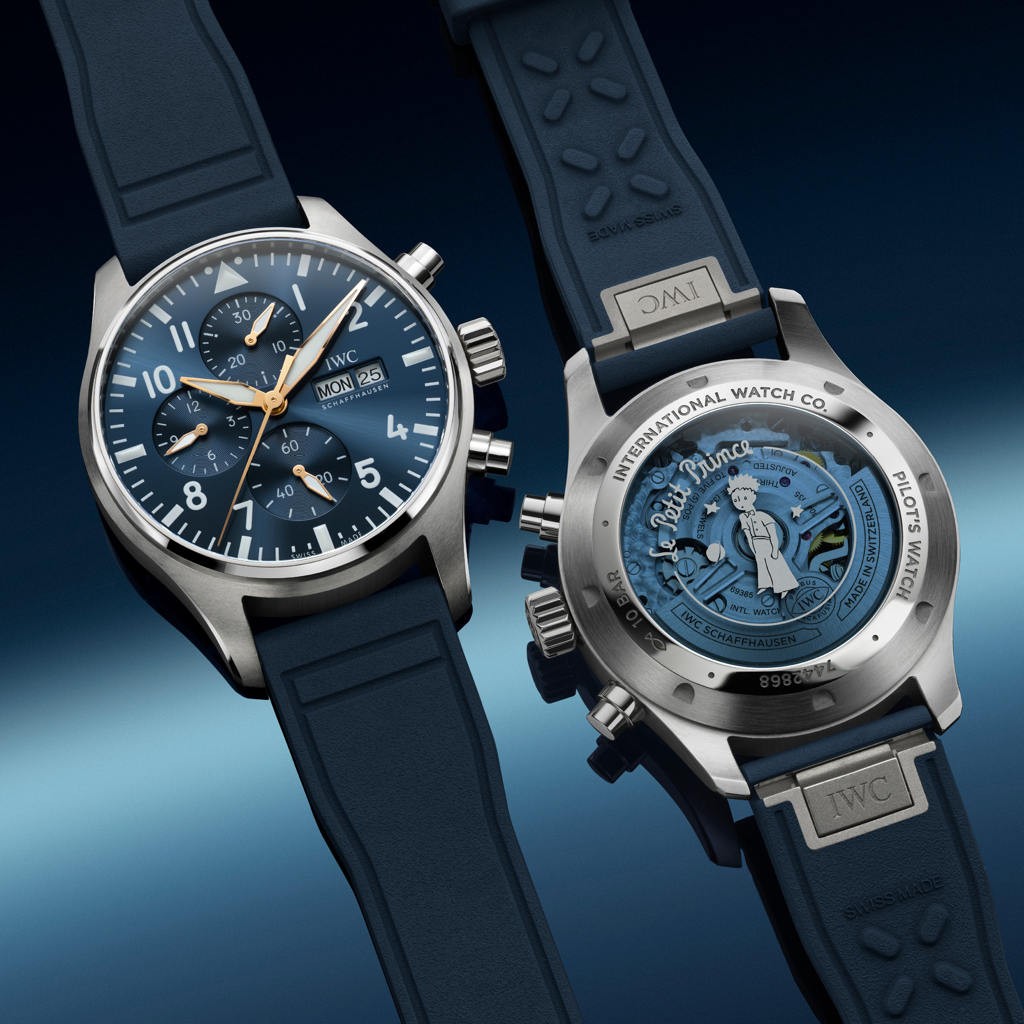 Two IWC Pilot's Watch Chronograph Edition "Le Petit Prince" watches with blue dials and straps, one showing the front and the other the engraved back.
