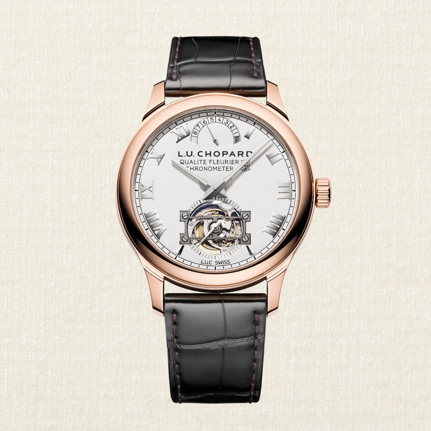 Rose gold watch with a white face, black leather strap, and visible tourbillon movement.