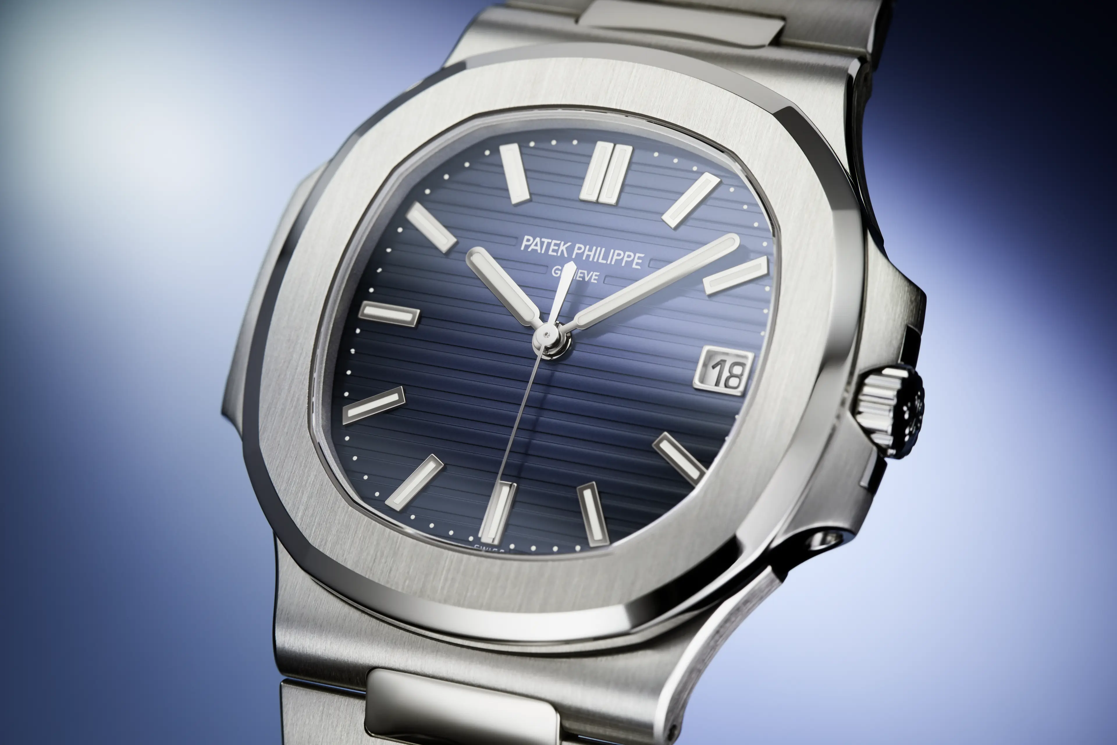 A close-up of a Patek Philippe Nautilus watch with a blue dial and stainless steel case and bracelet.
