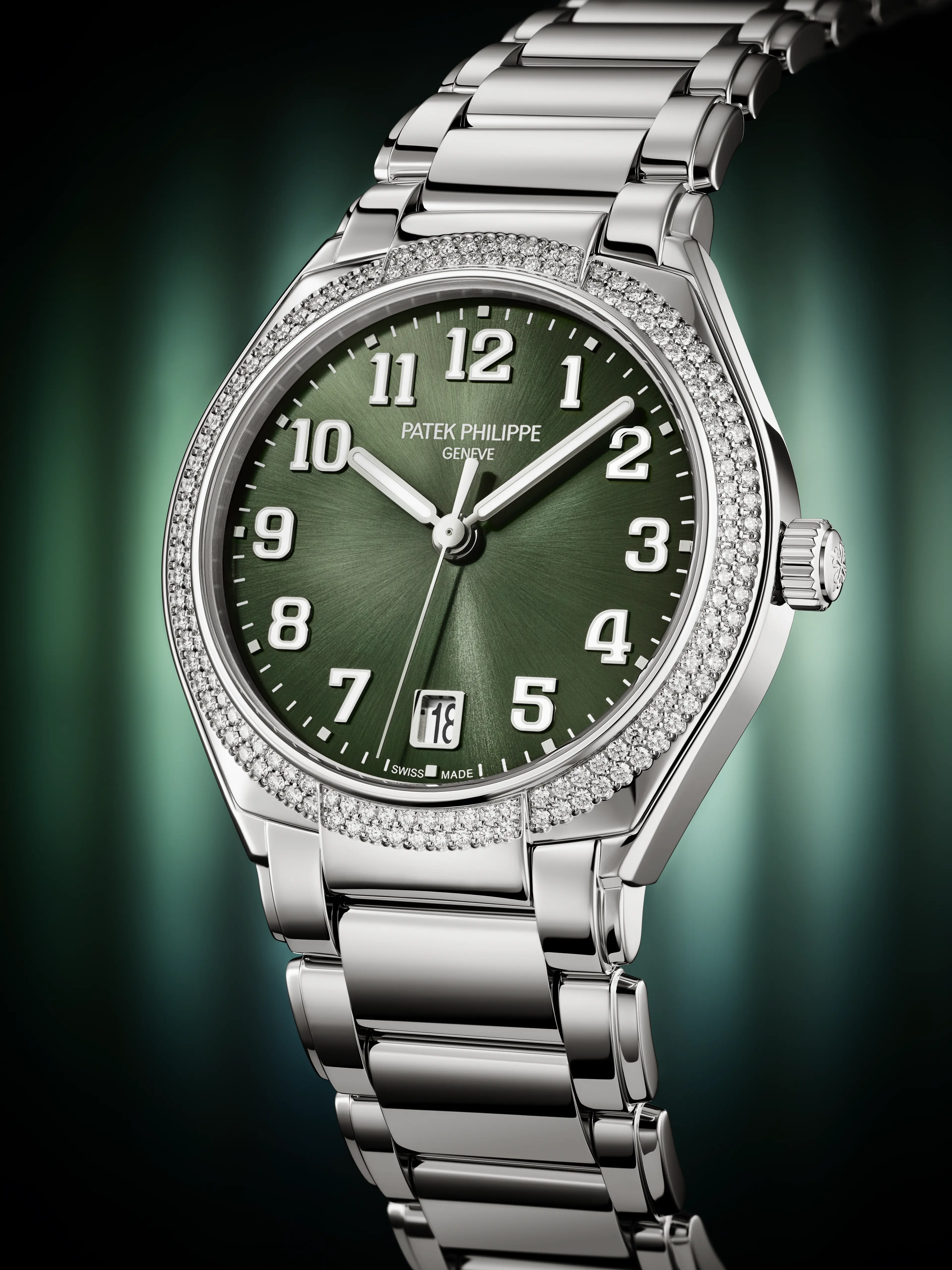 A silver Patek Philippe watch with a green face, diamond-encrusted bezel, and a date window at 3 o'clock.