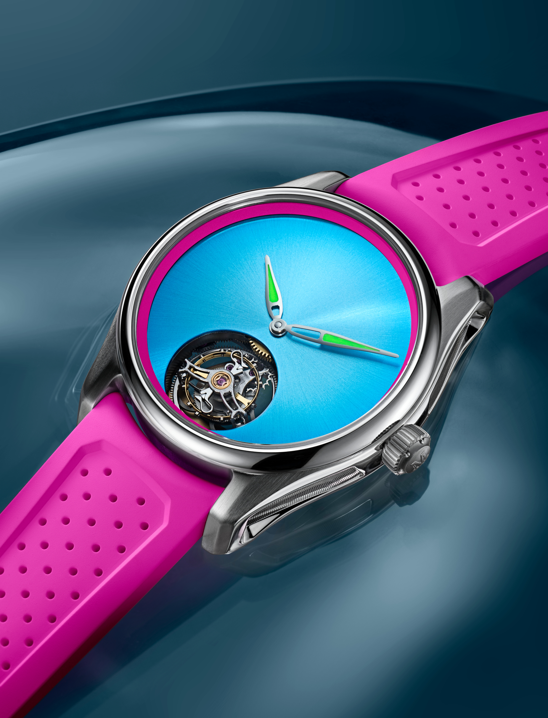 Une montre argentée avec un bracelet rose vif et un cadran bleu éclatant, dotée d'un mouvement tourbillon visible.