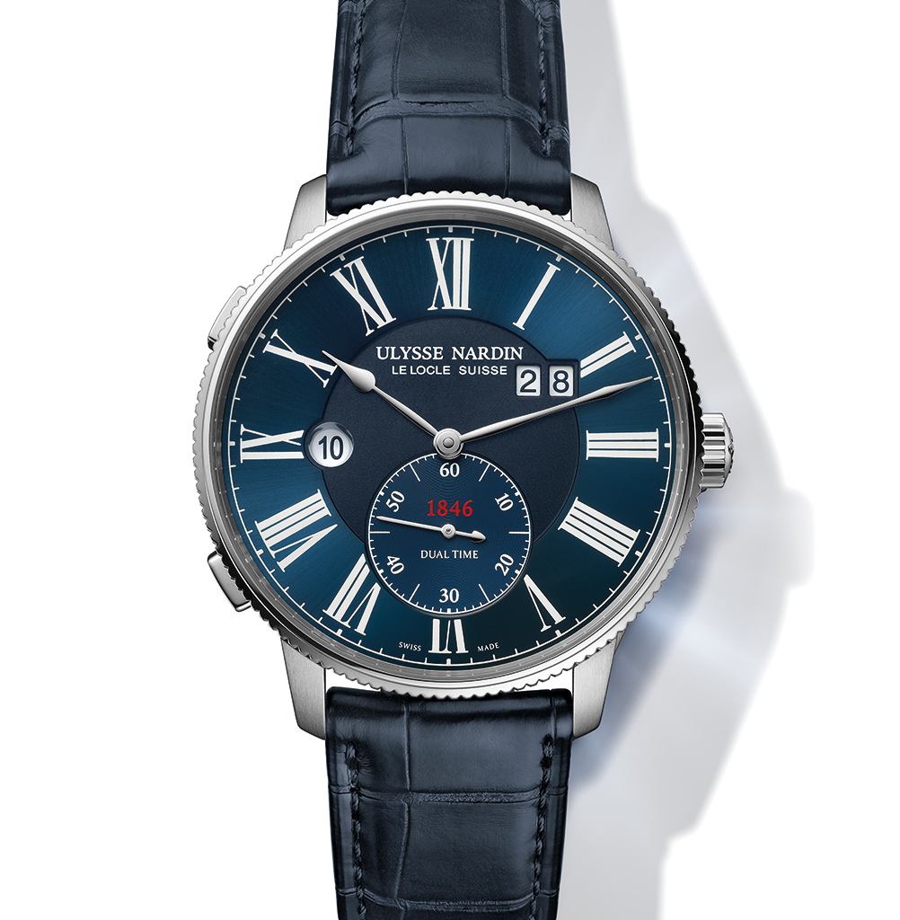 A Ulysse Nardin Dual Time watch with a blue face, Roman numerals, and a blue alligator leather strap.