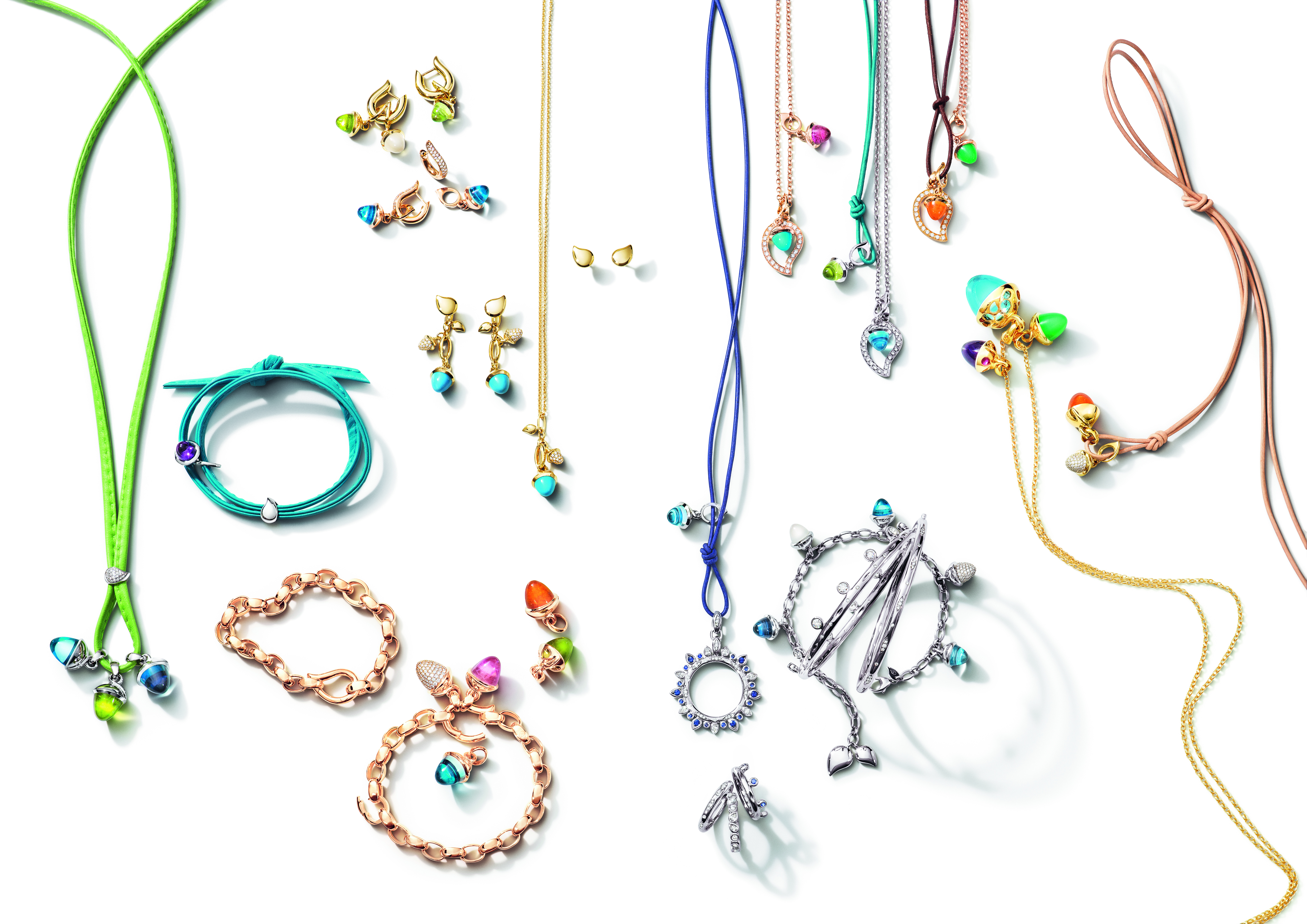A Tamara Comolli jewelry piece featuring elegant, rounded gemstones set in a refined arrangement. The gemstones have vibrant colors.