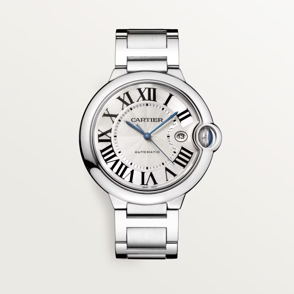 A silver Cartier Ballon Bleu watch with a white dial, Roman numerals, blue hands, and a date window.