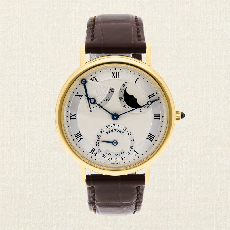 A gold Breguet watch with a white face, Roman numerals, a moon phase indicator, and a brown leather strap.