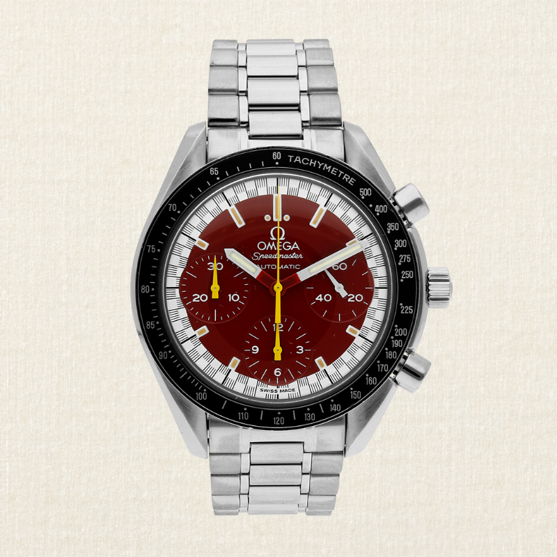 A silver Omega Speedmaster watch with a dark red dial and black bezel.