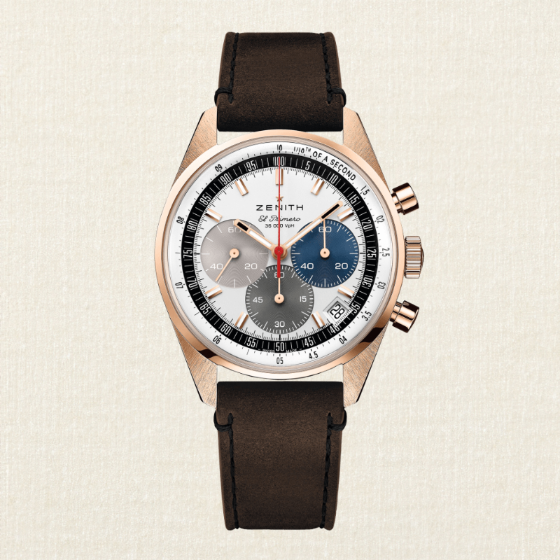 A Zenith El Primero Chronomaster Sport watch with a rose gold case, white dial, and brown leather strap.