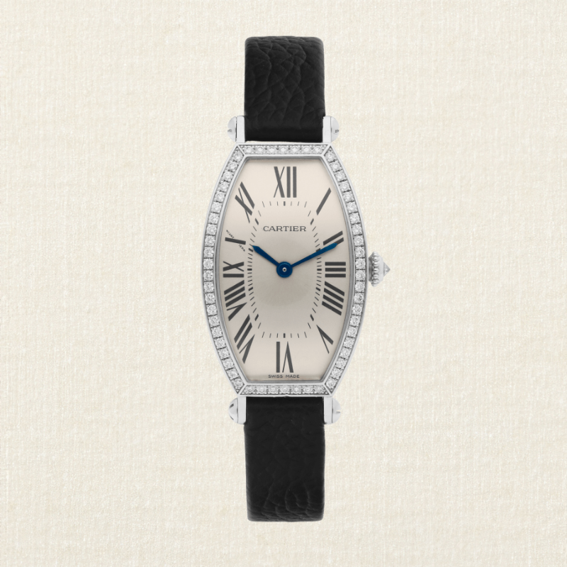 Et Cartier Tonneau-ur med diamantbesat hvidguldsurkasse, sort læderrem og sølvfarvet urskive med romertal.