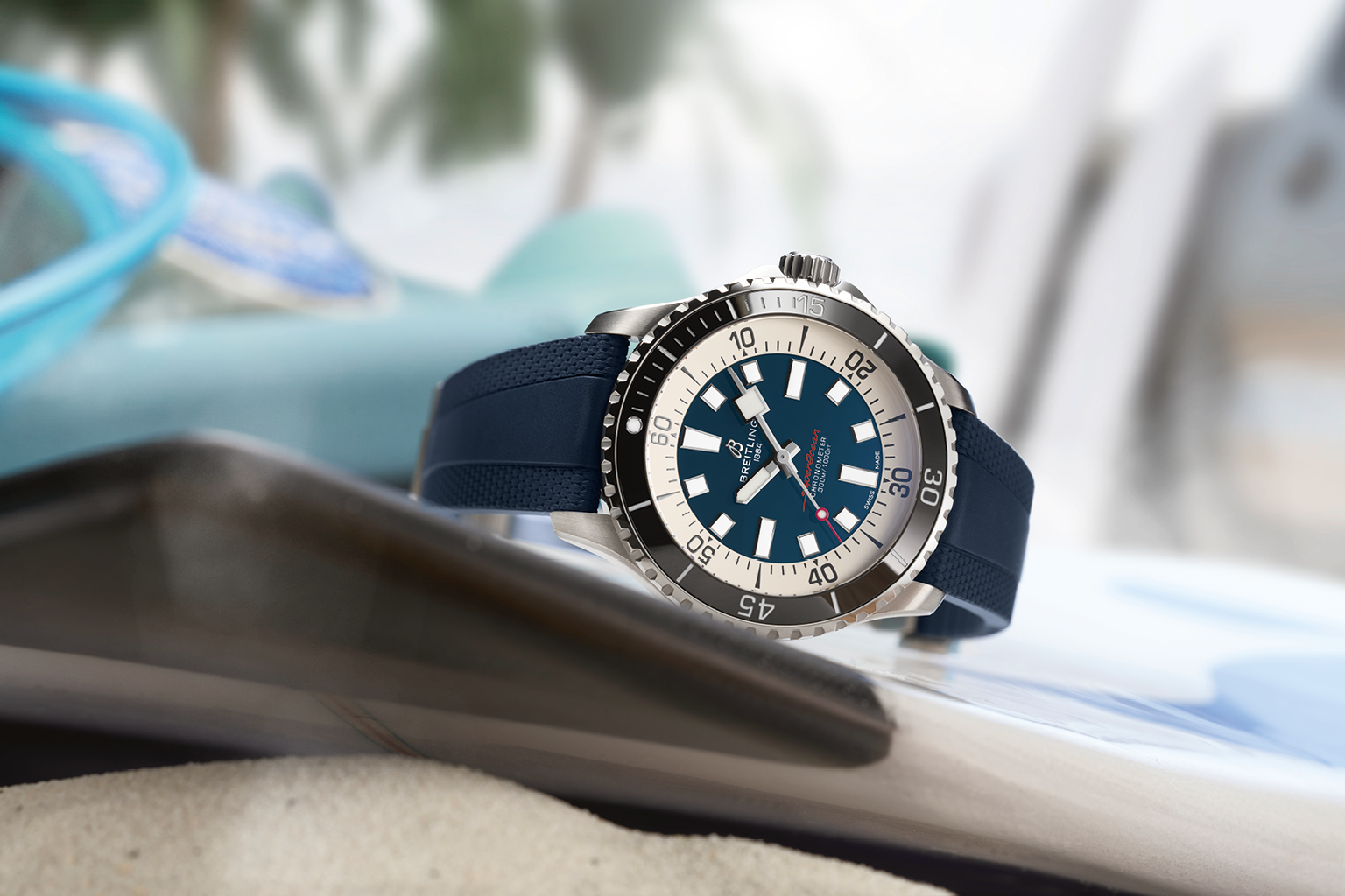 A Breitling “Superocean Automatic 42” with a blue rubber strap and a steel bezel.