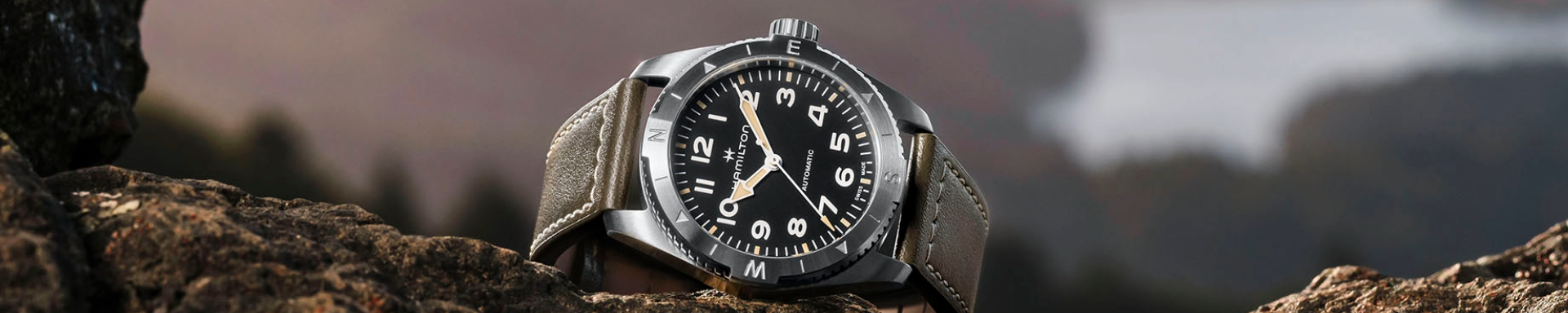 Hamilton watch, green leather strap and black dial.