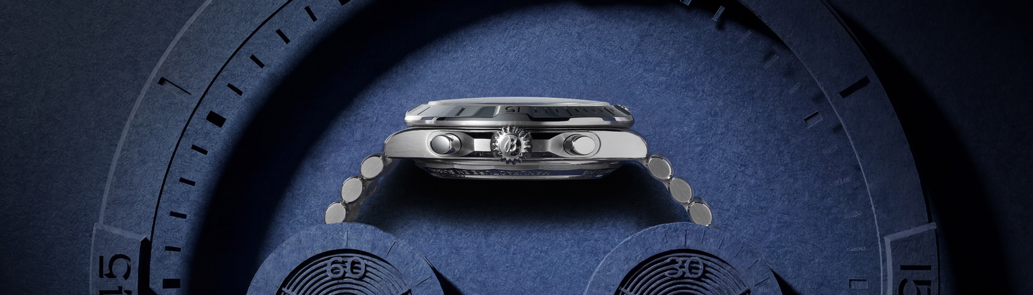 BREITLING wristwatch, shown from the side on a navy blue background.
