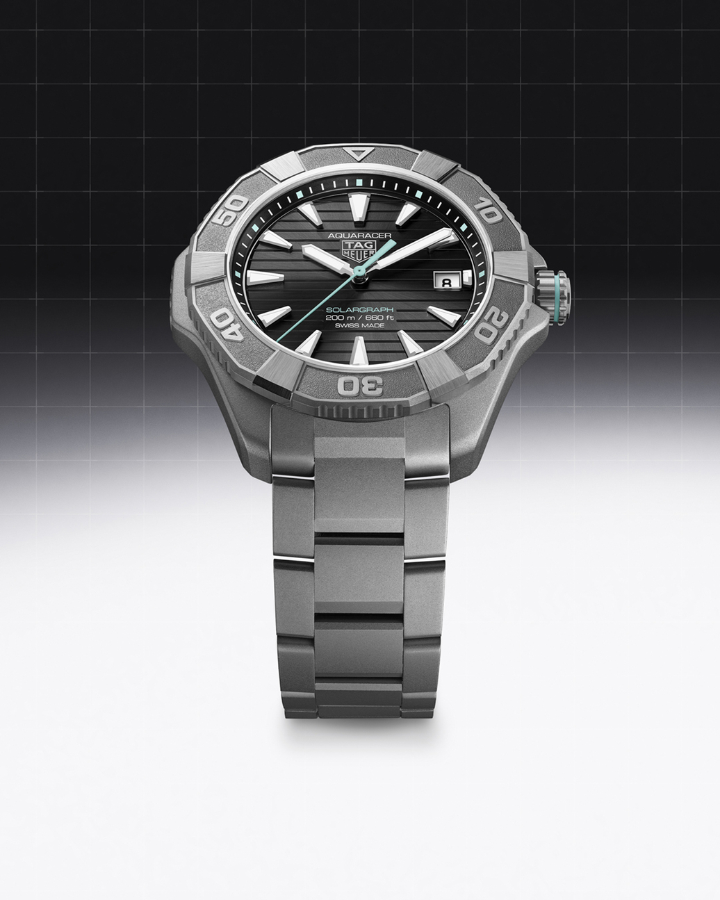 A silver Tag Heuer Aquaracer Solargraph watch with a black face and turquoise accents.