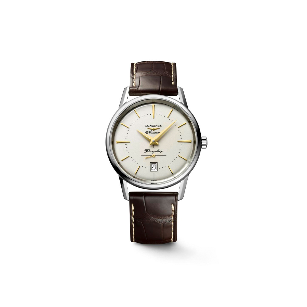 Longines Flagship automatic wristwatch with a silver dial, gold markers, and a brown leather strap on a white background.