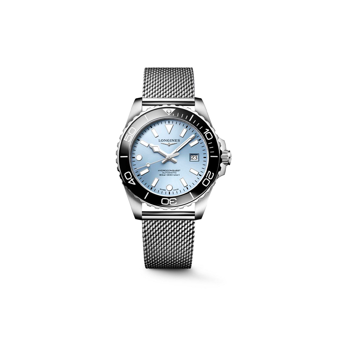 Longines HydroConquest automatic watch with a light blue dial, black bezel, and a stainless steel mesh bracelet.